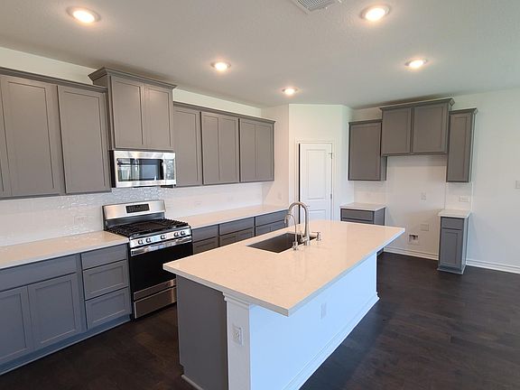 White quartz counter tops with gray 'veins', grey accents were an upgrade as were the gray cabinets.