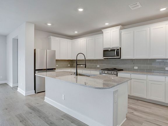 Upgraded kitchen with oversized cabinetry.