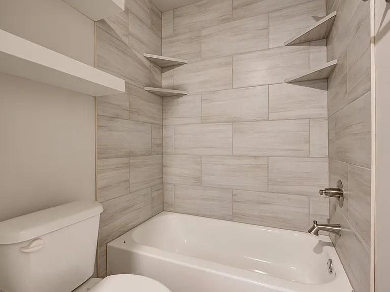 Bathtub and above the toilet shelving