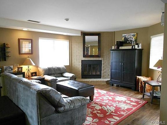 Living room has fireplace and lots of natural light