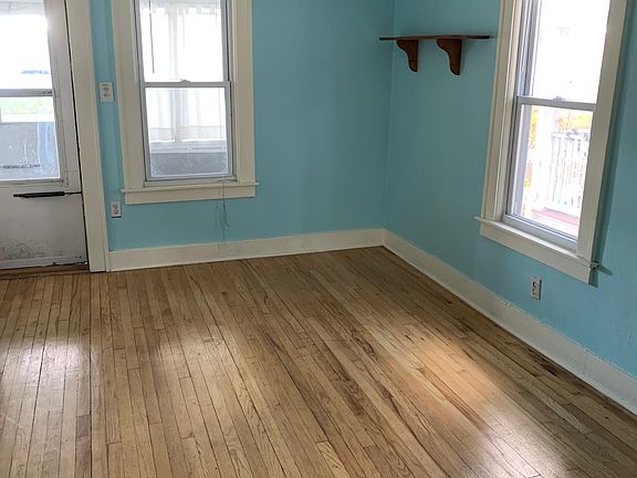 Living Room with mini blinds facing the front of the house. 
11'x12'