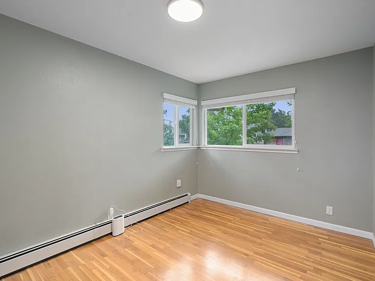 Bedroom with beautiful corner windows.