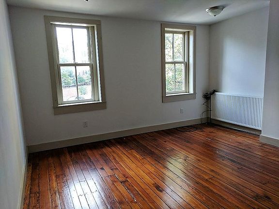 Spacious Living Room with Original Hardwood Floors