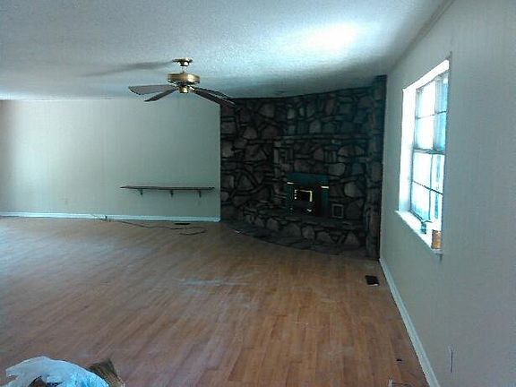 Living room with fireplace and ceiling fans
