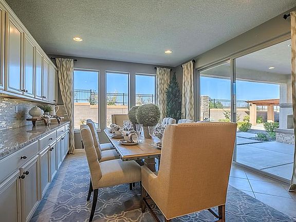Dining room has cabinets with granite counters for additional storage.