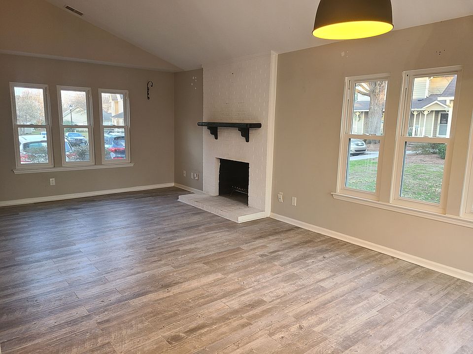 Open concept living room and dining room. With cozy working fireplace