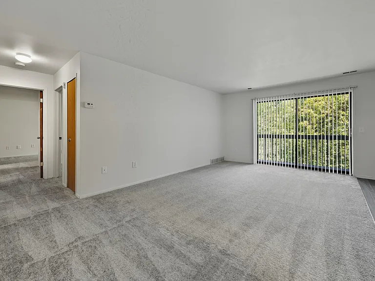 Open Living Room with natural light at Franklin River Apartments in Southfield, MIng Room with natural light at Franklin River Apartments in Southfield, MI