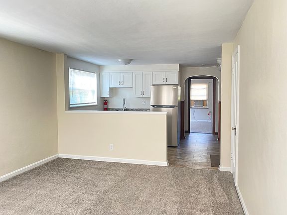 Living room looking into kitchen/hallway to bedroom
