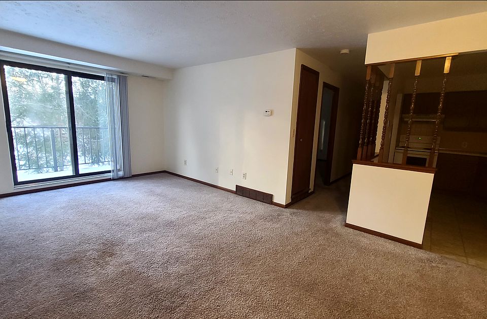 Main living space and view of balcony and hall area that leads to the bedroom, bath and hall cabinet