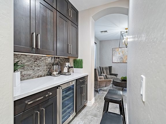 Storage and Bar area off of the kitchen through to a seating area with table "dinning"