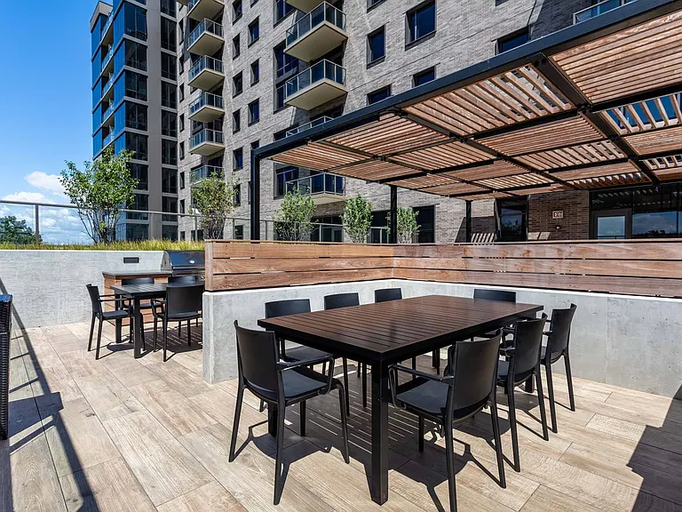 Gather around the table on the rooftop, the perfect spot to enjoy a meal or drinks while taking in the scenic views.