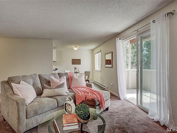 Lots of natural light in the living room, with a balcony overlooking the peaceful back yard area. 