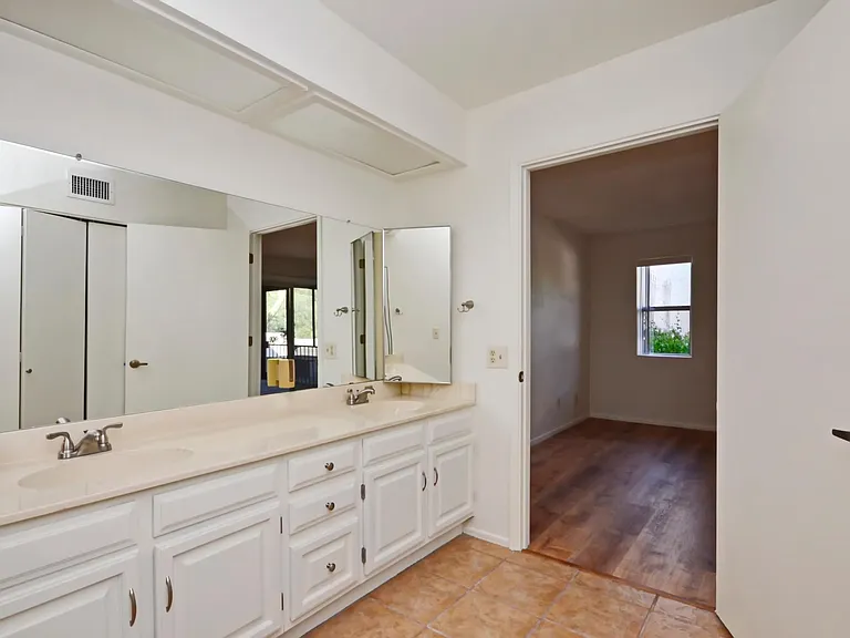Primary bathroom with dual sink vanity and lots of closet space.