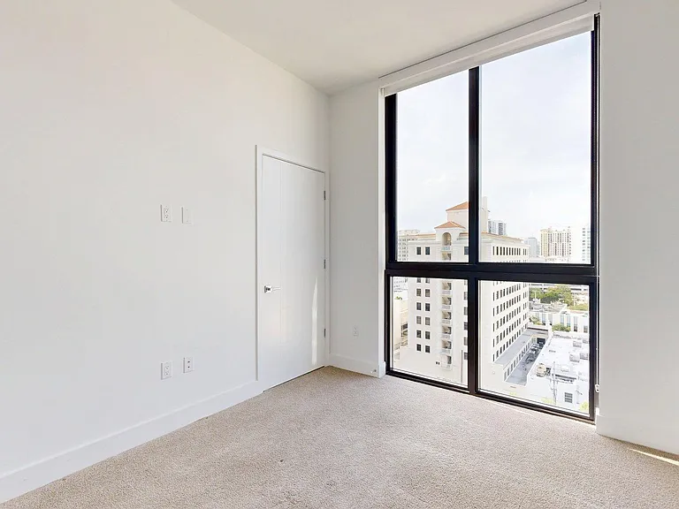 Spacious apartment Bedroom with carpet floors.