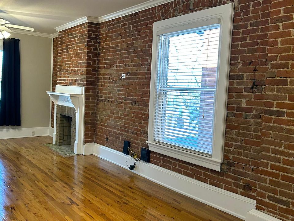 Exposed brick wall with decorative fireplace original to building