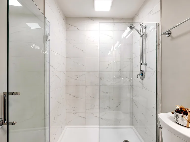 Beautifully designed primary bathroom with dual vanities and a luxurious walk-in shower.