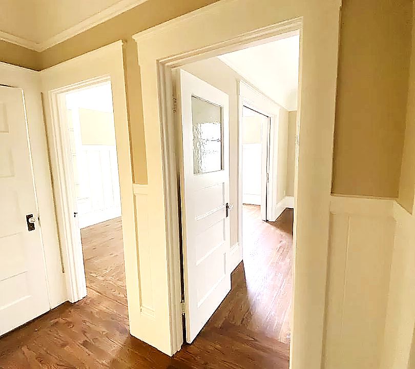 Kitchen Hallway: The unit has newly finished hardwood floors, a living room, bedroom, walk-in closet, bathroom and utility room.
