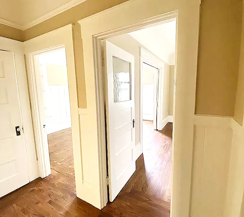 Kitchen Hallway: The unit has newly finished hardwood floors, a living room, bedroom, walk-in closet, bathroom and utility room.