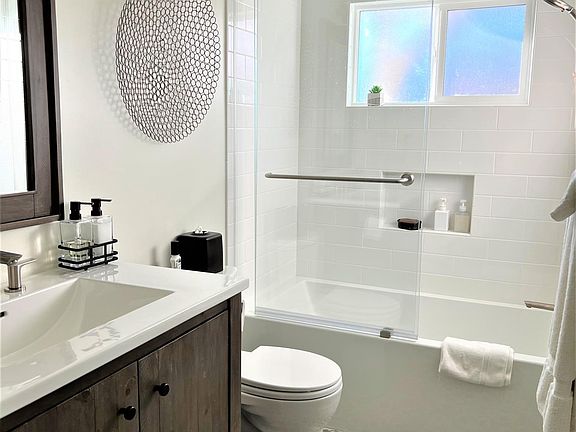 Shower has windows that look out towards the backyard