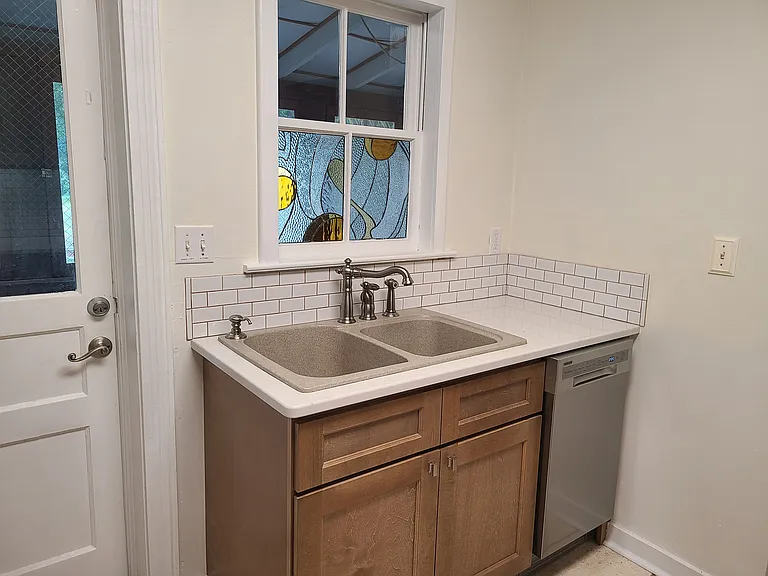 Sink with 18" dishwasher. Original stained glass window.