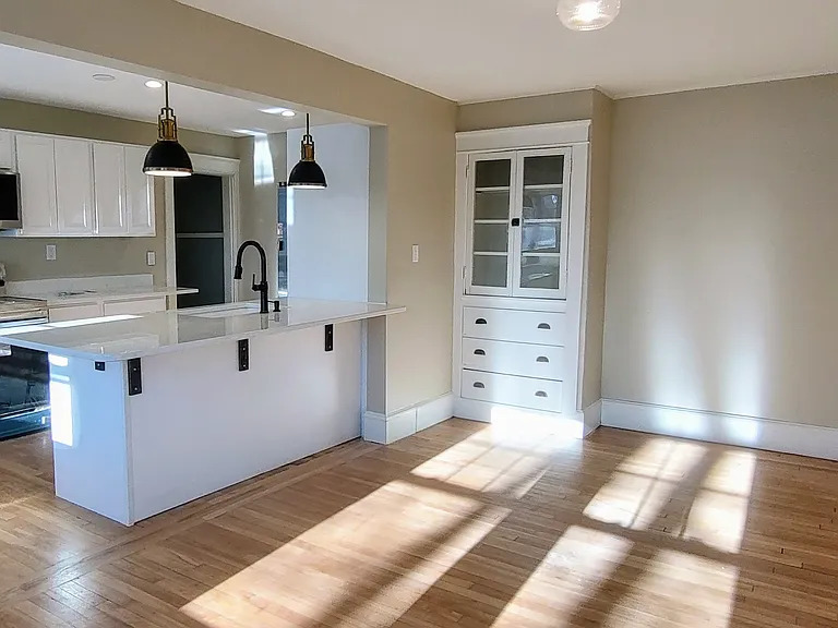 This unit is so sunny! Spot the sweet built-in in the dining room.
