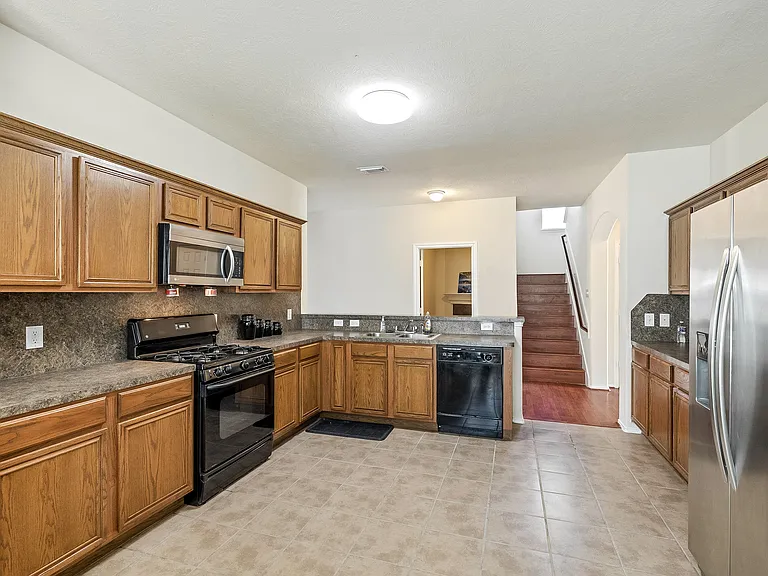Enjoy some grub in this gorgeous and spacious open concept kitchen with gas stove and stainless steel refrigerator!