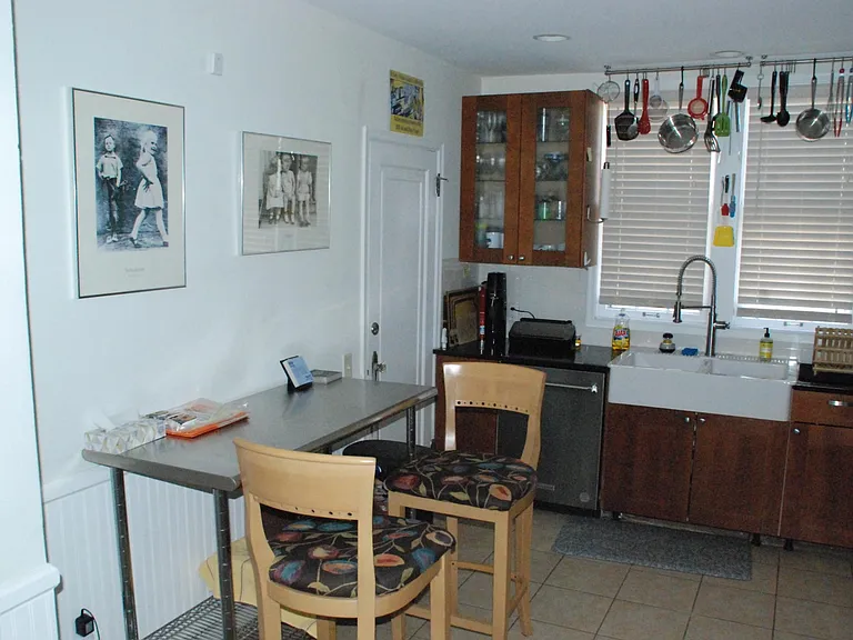 Door on north wall leads to side exit, basement and back stairs to upstairs unit. Owner is 6'4" so liked "hanging pots." (Not for everyone as they were "way up there."