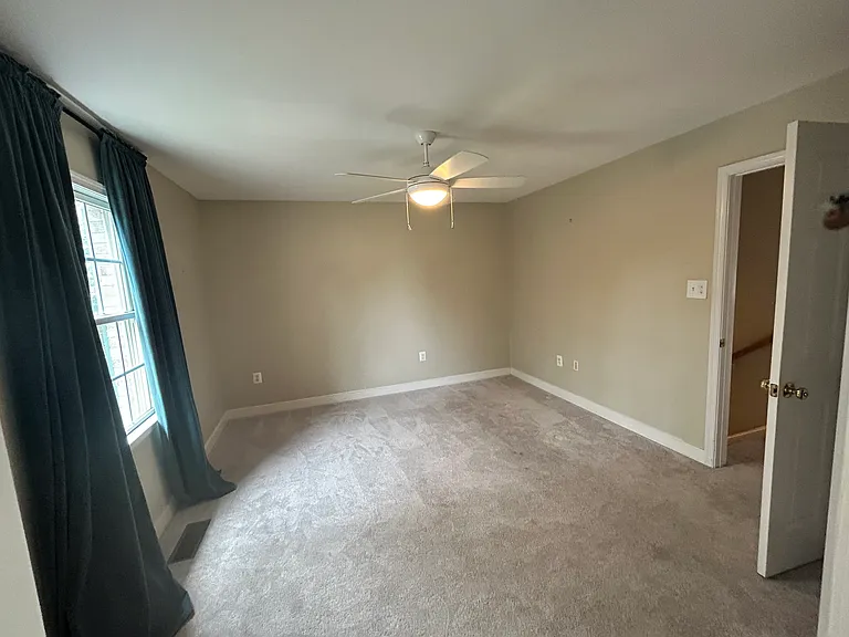 Front-facing bedroom on second floor. Spacious with fan, attached bath and walk-in closet