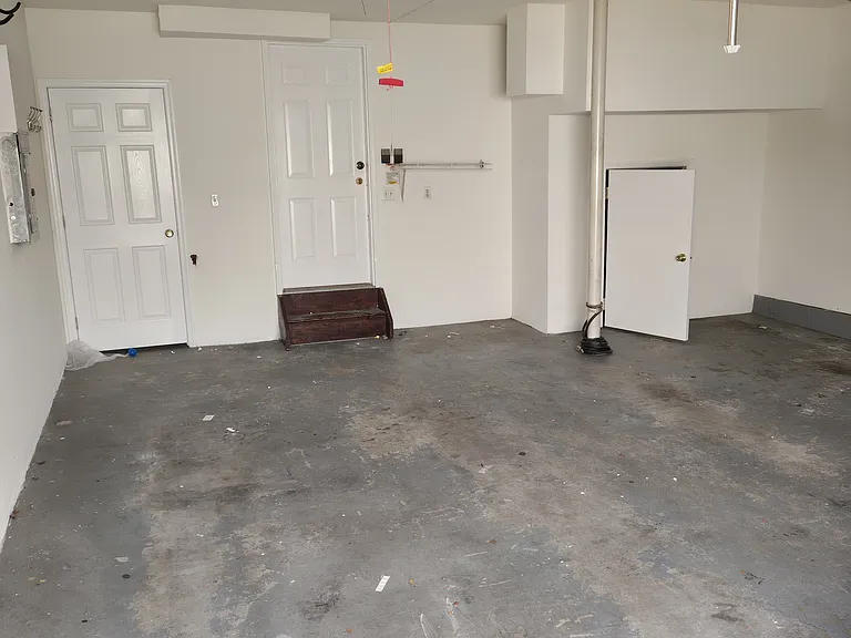 Well_designed basement two_car garage offering a neat interior layout and ample maneuvering space.
