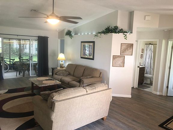 Newly remodeled interior spacious living room with vaulted ceilings, microfiber couches leather recliner enclosed sun room on back with remote controlled ceiling fans throughout
