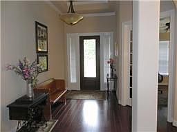 Stunning Foyer with Hardwood Flooring Greets Your Guests