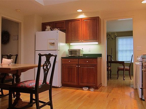 The Eat-in Kitchen is the hub of the house and boasts plenty of Cherry cabinetry, recessed lighting & skylight, real hardwood flooring, and easy flow into the Formal Dining Room or Family Room.