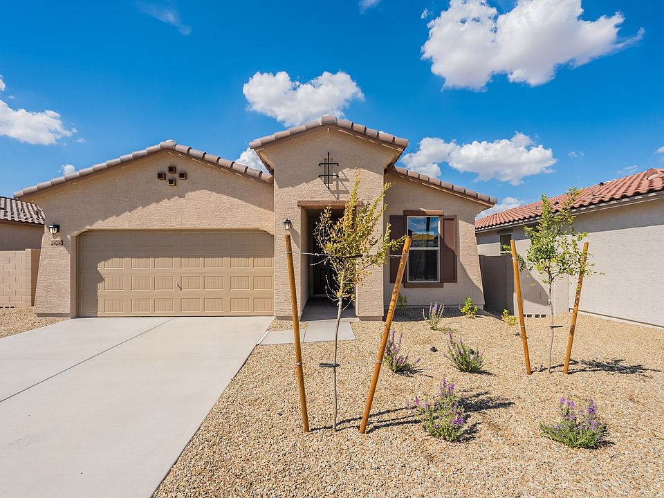 Elegant stucco facade and rustic tile roof harmonize with desert landscaping. Located in picturesque