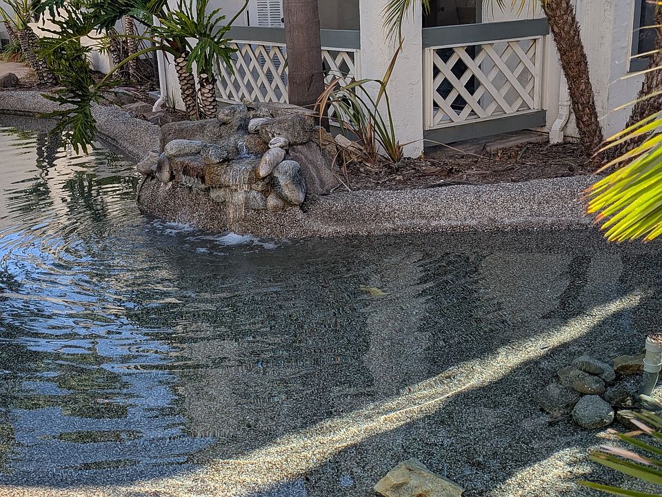 This is the private, 1st floor patio for unit 104. Note soothing waterfall feature and large, secure patio storage closet.