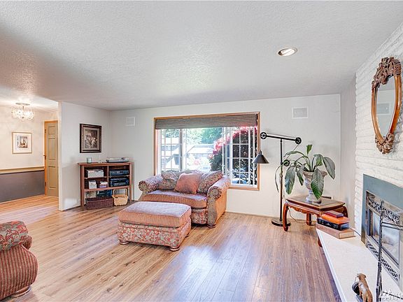 Large formal living room is just off the entry!Engineered laminate, gas insert w/controlled heating and large window overlooking the yard!