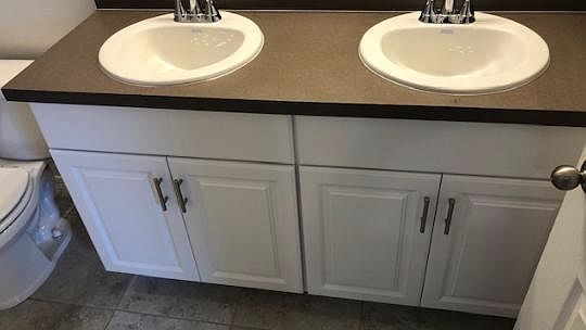 Double vanity in the master bathroom with gorgeous white cab
