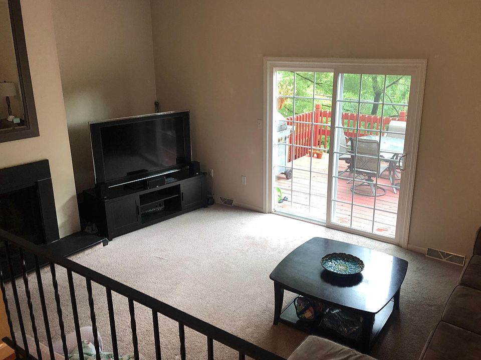 View of cozy sunken family room from dining room. (Note - tenants are NOT permitted to use fireplace.)