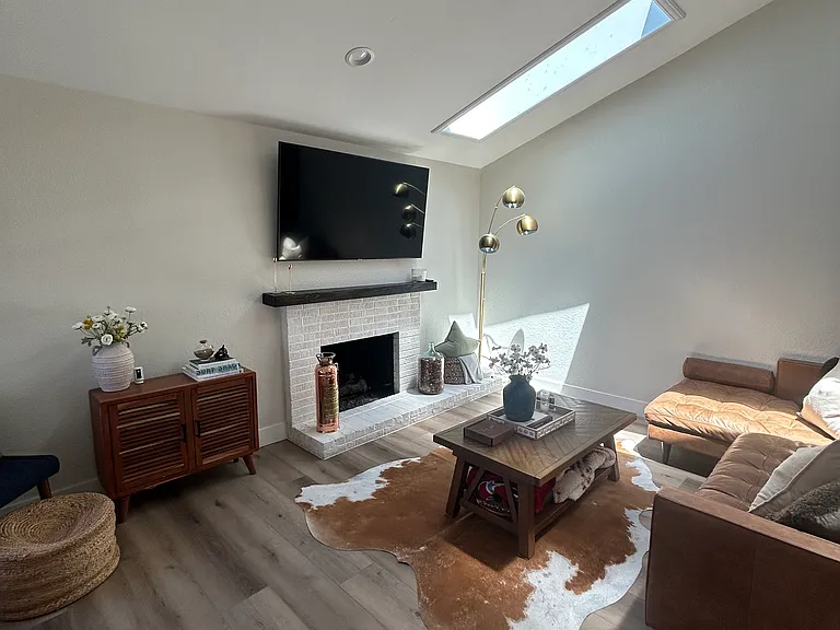 Classic & Modern looks with original fireplace and wooden beam mantle.