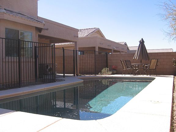 Solar heated swimming pool and covered patio.