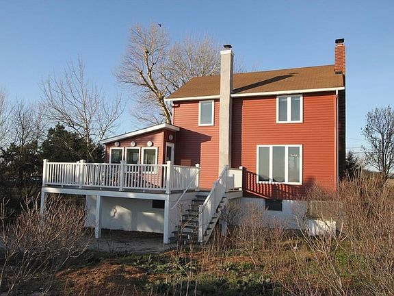Rear elevation of home showing new stairs from deck that provides easy beach access.