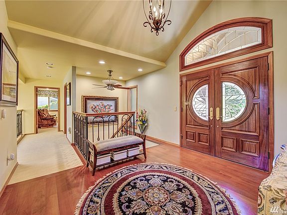 As you enter the home you are greeted by a grand foyer with Brazilian rosewood floors. The custom French door is made out of African mahogany and has beautiful beveled glass inlay to impress your guests.