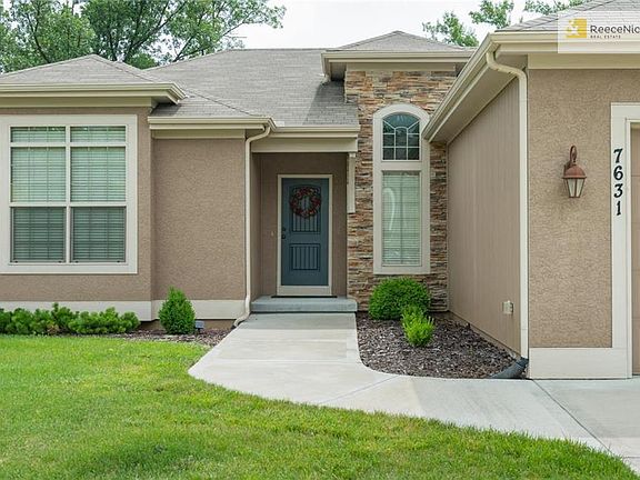 ENTRY WITH GORGEOUS WINDOWS, STONE ACCENT & METICULOUS LANDSCAPING