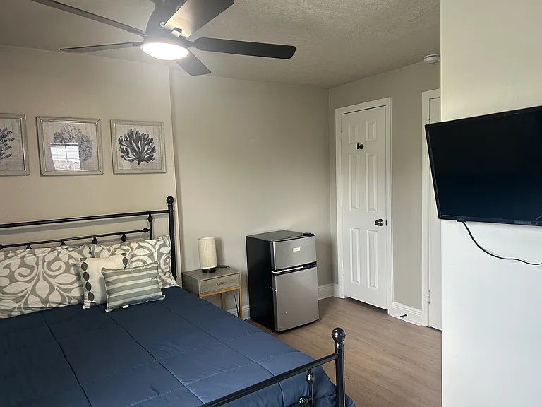 Room 1 with large closet, mini refrigerator, smart TV, workstation, full size bed with luxury mattress, blackout curtains etc.