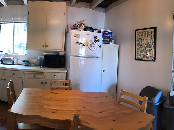 An odd panorama shot of the kitchen.