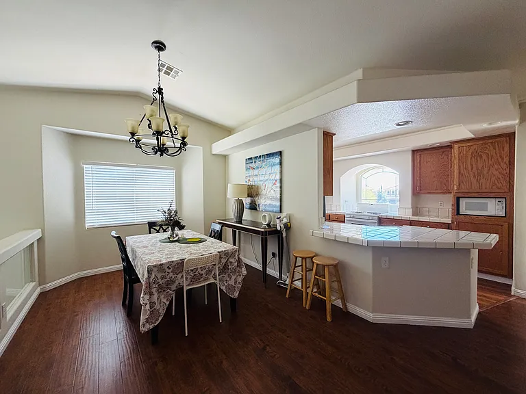 Bright shared dining area with breakfast bar, swivel bar stools and 24X7 warm ambient lighting