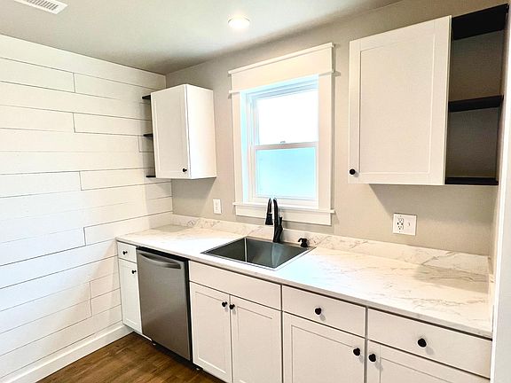 All white kitchen with shiplap wall