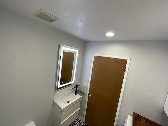 Downstairs restroom with laundry unit
