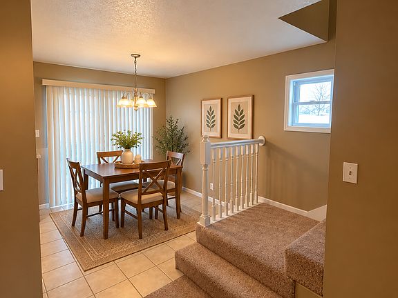 The beautifully appointed kitchen combines warm finishes with easy-care tiled flooring and a bright adjoining dining space, offering both style and everyday practicality.