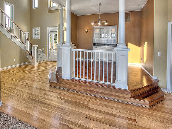 Gorgeous hardwood floors flow from the grand entry to the formal dining room.