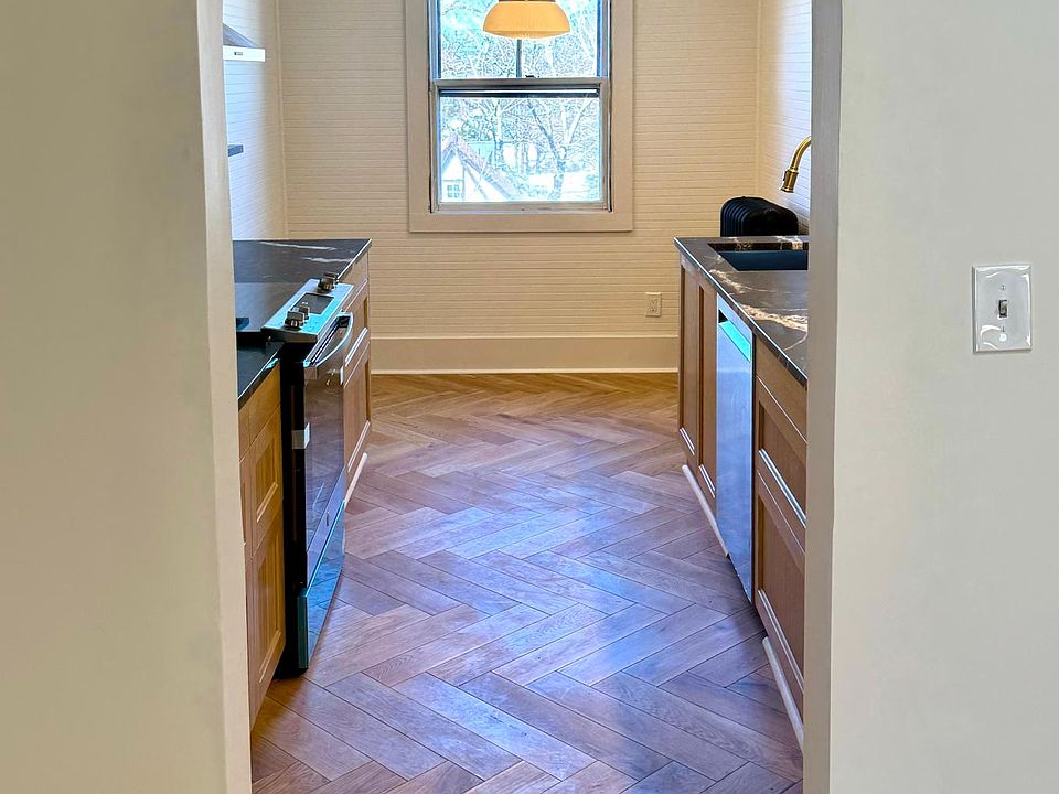 Kitchen entrance with area for small dining table against window.